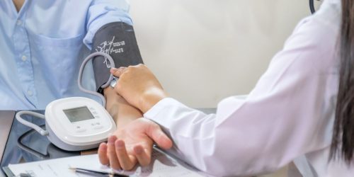 doctor-examines-the-patient-s-pulse-with-stethoscope-and-records-the-results-health-medical-checkup.jpg