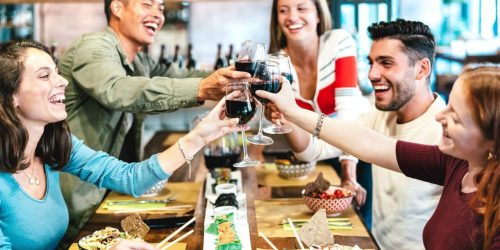 multiracial-friends-toasting-red-wine-at-sushi-restaurant.jpg